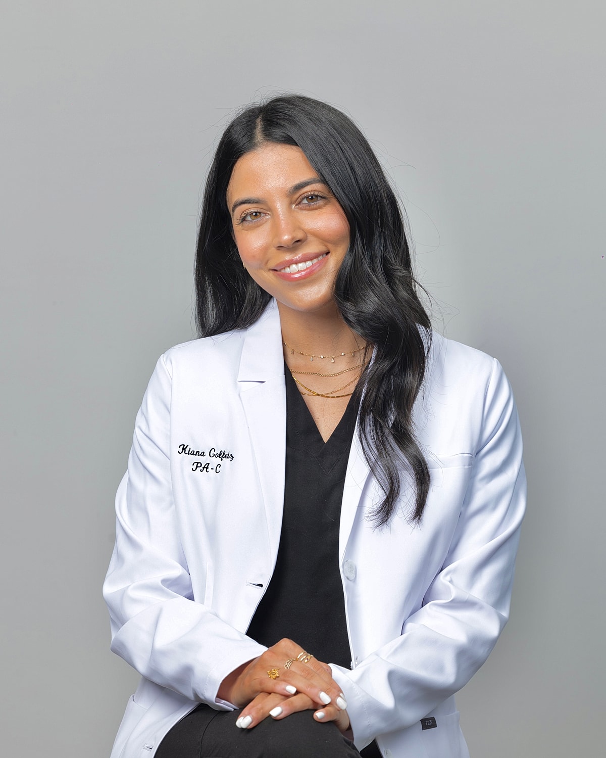 Smiling medical professional in white lab coat.