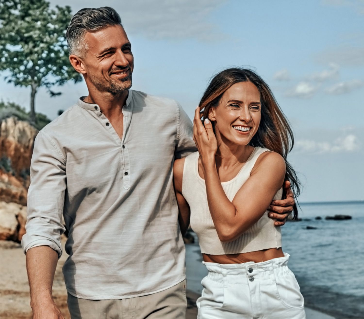 Couple enjoying a happy moment by the beach.