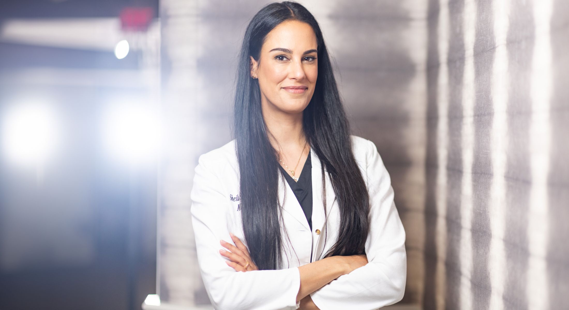 Female professional in a white lab coat.
